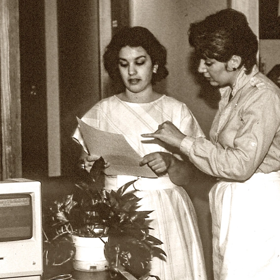 Two employees collaborating at the SEI's first office in the late 1980's.
