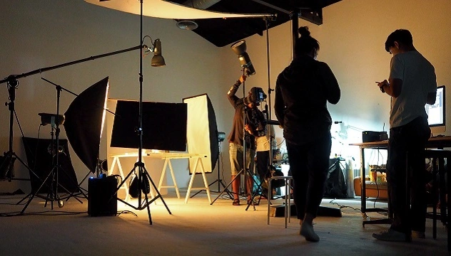 Individuals in a film studio create content for the SEI Innovation Snapshots video series.