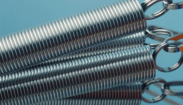 Close-up of a group of metal springs on a blue background.