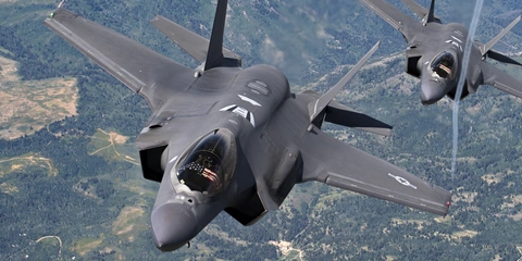 Two fighter jets flying in formation.