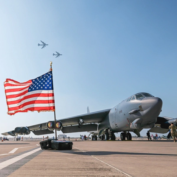 Military plane with U.S. Flag  in the foreground.