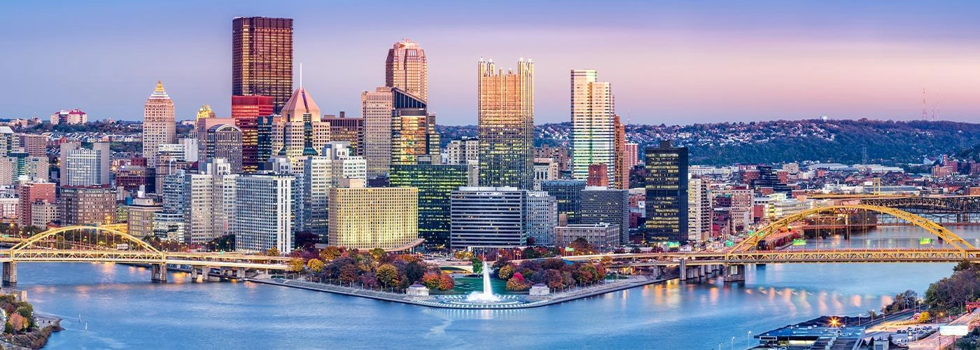 Downtown Pittsburgh skyline at dusk.