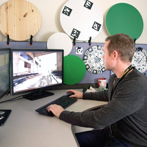 An SEI employee working on a desktop computer.